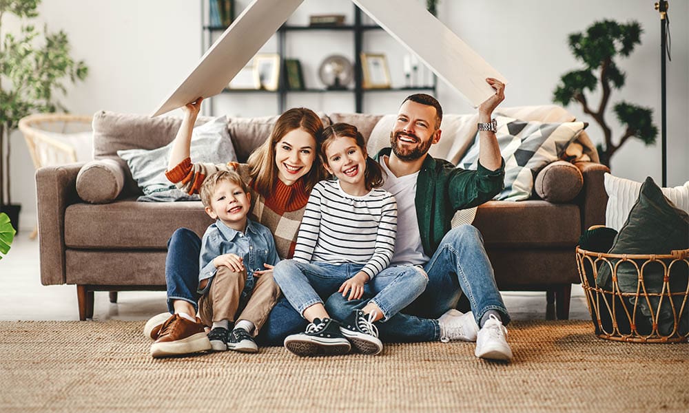 How to Lower Your Rental Property Insurance Premium - Concept Housing a Young Family. Mother Father and Children in New Home